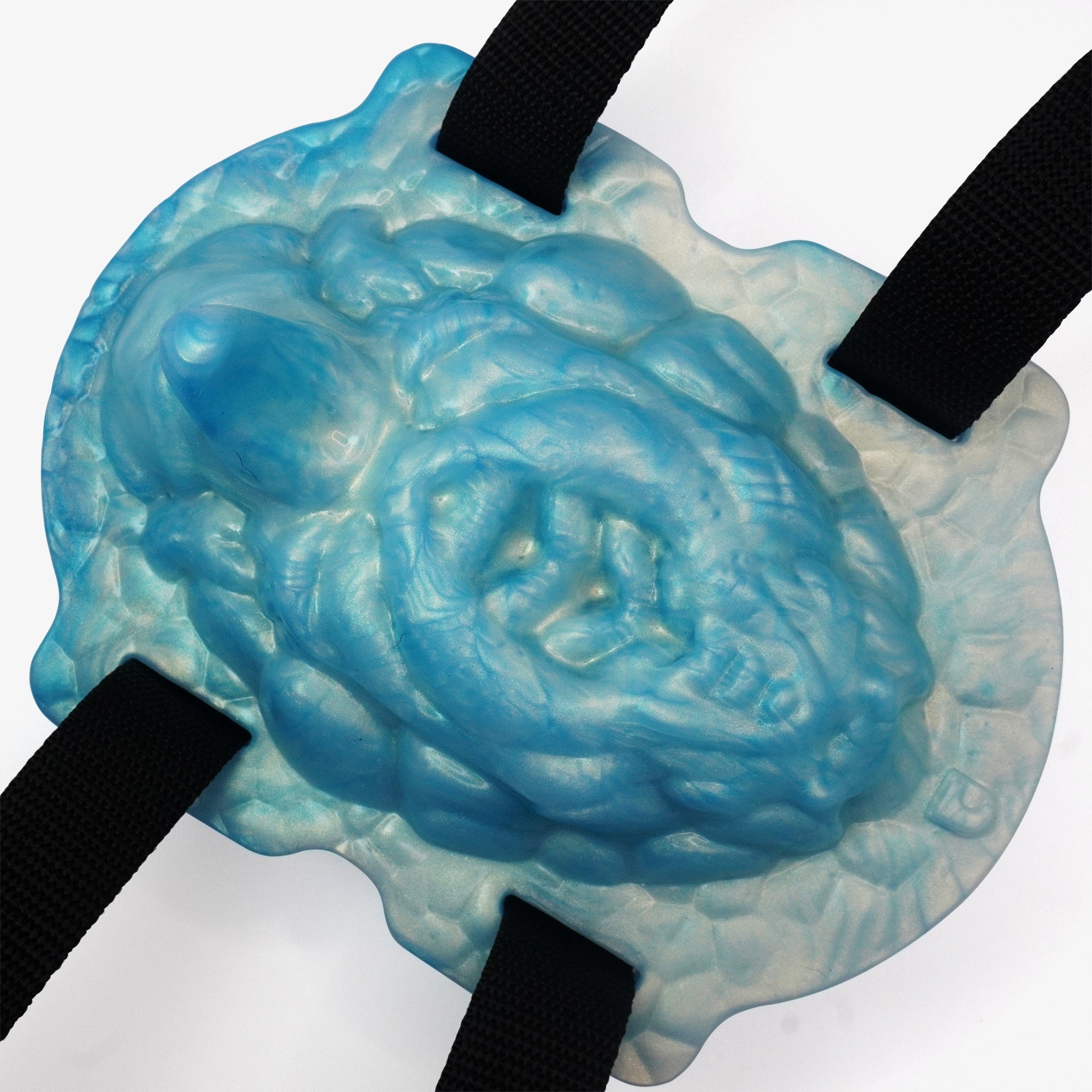 The coral keeper grinder laying down with straps.